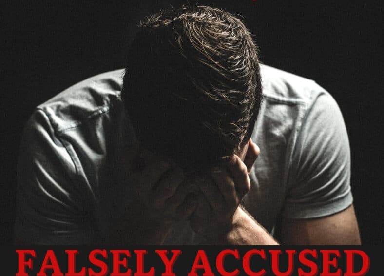 Man in despair sitting behind text that says falsely accused, beating false allegations